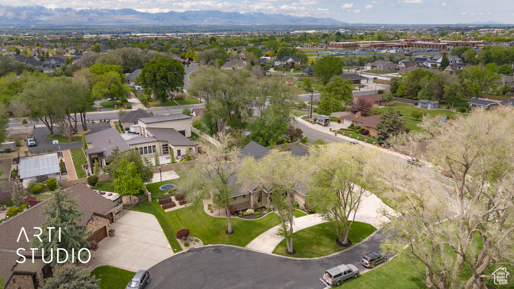 Aerial view of property and surrounding area with nearby suburban area and mountains