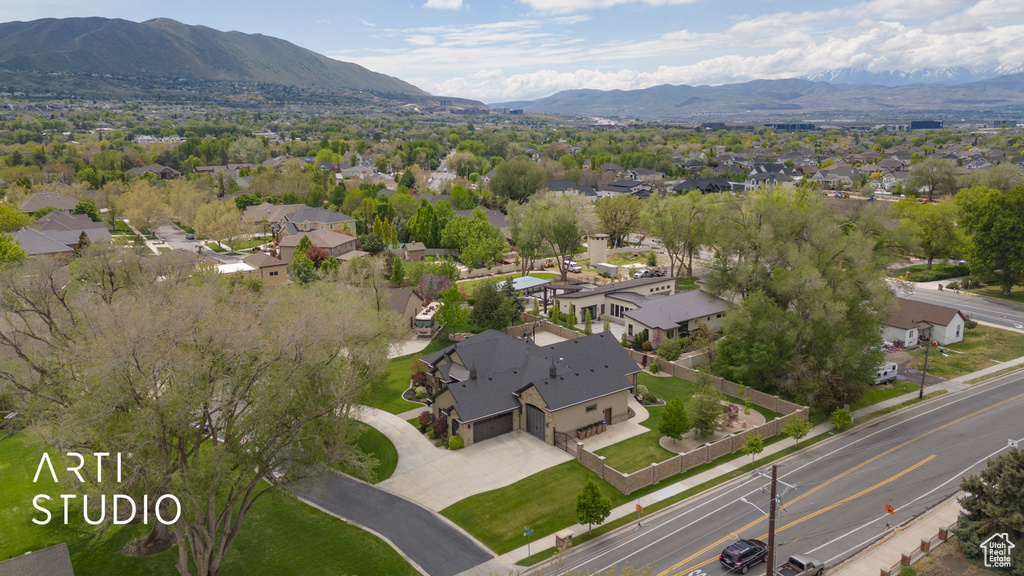 Aerial view of property's location with a mountain backdrop and nearby suburban area