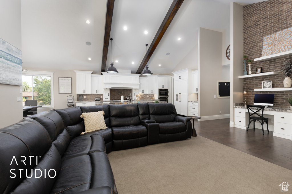 Living area with dark wood-style flooring, high vaulted ceiling, beam ceiling, an office area, and recessed lighting