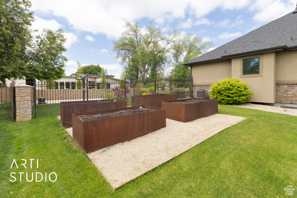 View of yard with a vegetable garden and cooling unit