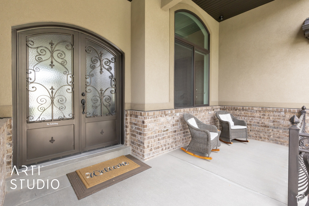 View of exterior entry featuring stucco siding and brick siding