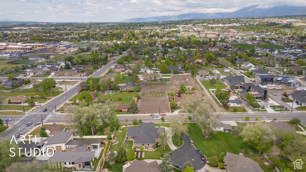Aerial overview of property's location featuring nearby suburban area and a mountain backdrop