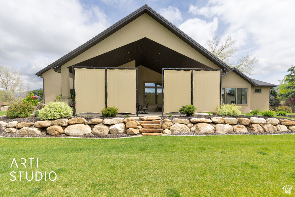 View of home's exterior with a lawn and stucco siding