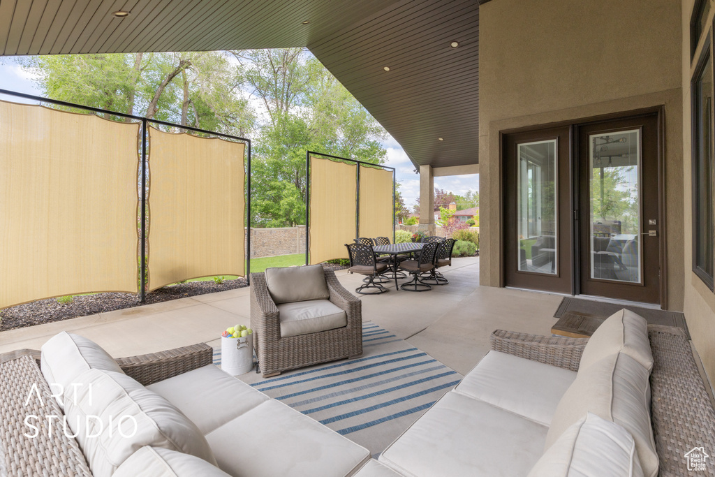 View of patio with outdoor lounge area, outdoor dining space, and fence