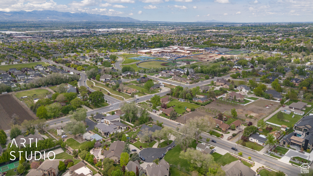 Aerial view of property's location featuring a mountain backdrop and nearby suburban area