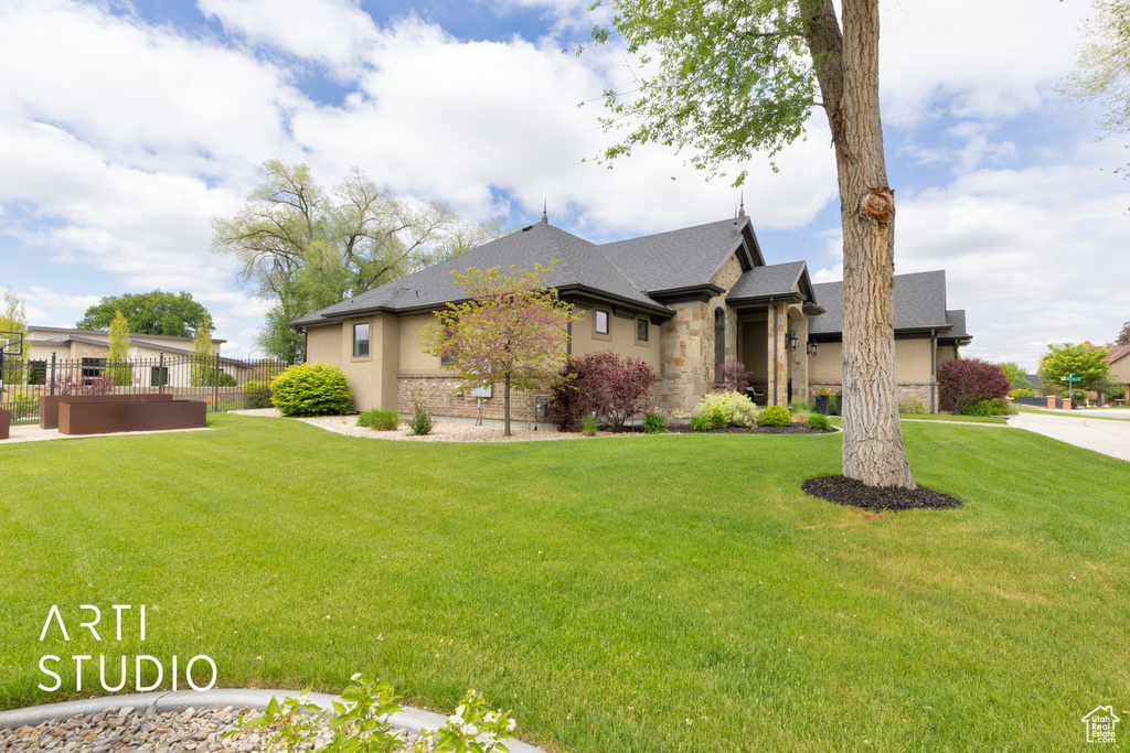 View of front of home with stone siding, stucco siding, and roof with shingles