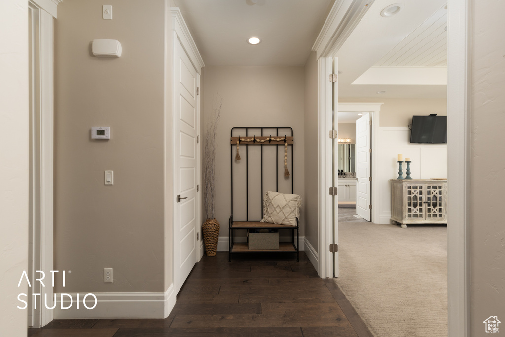 Hall featuring baseboards, recessed lighting, and dark wood finished floors