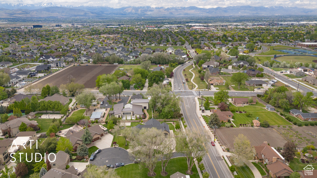 Aerial view of property's location featuring a mountain backdrop and nearby suburban area