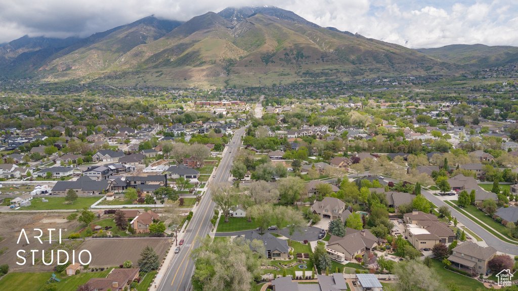 Aerial view of property's location featuring a mountainous background and nearby suburban area