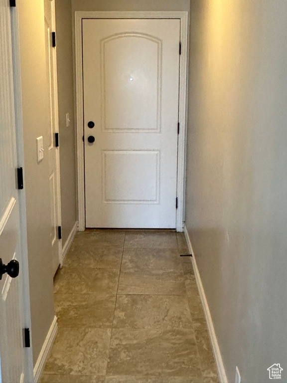 Doorway to outside featuring baseboards