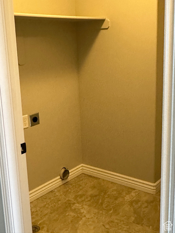 Washroom with electric dryer hookup and baseboards