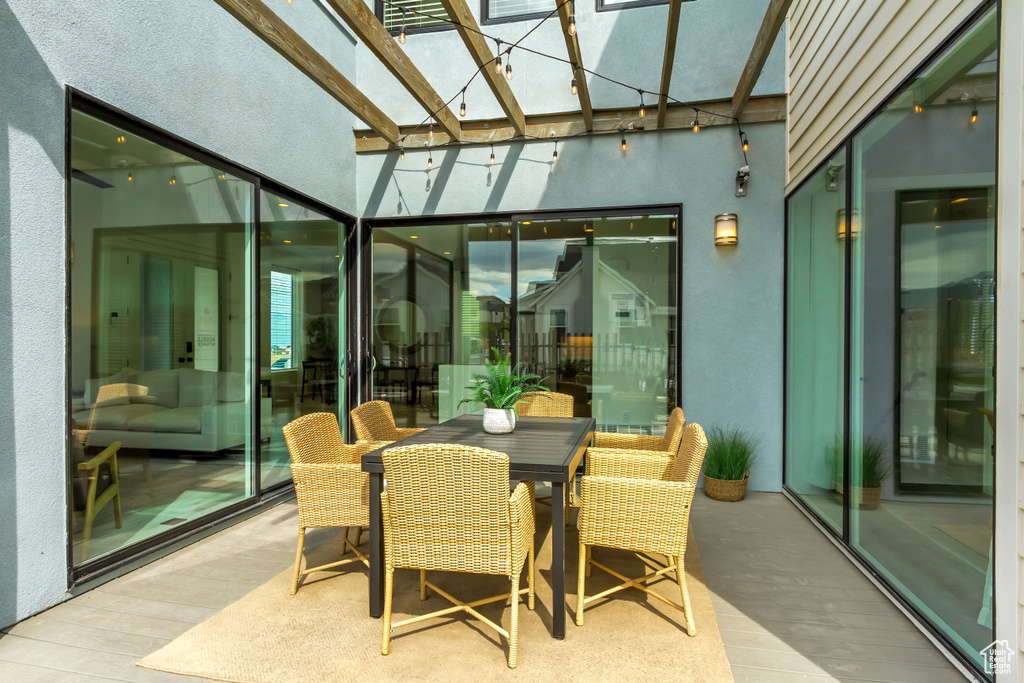 Sunroom / solarium featuring a skylight, wood finished floors, and a towering ceiling