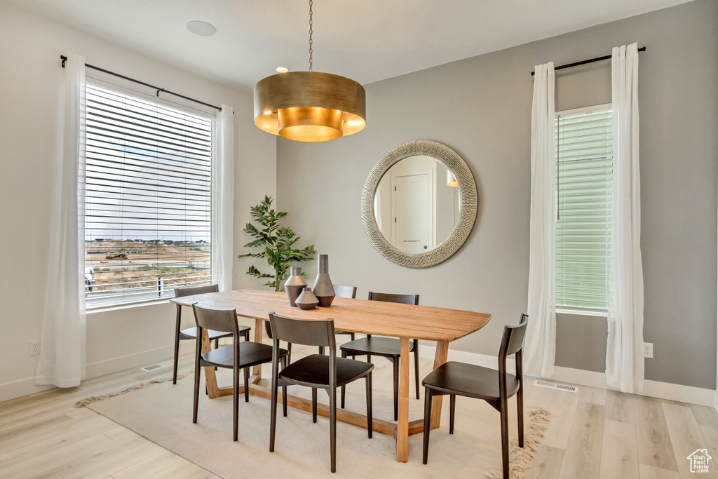 Dining room featuring light wood finished floors and baseboards