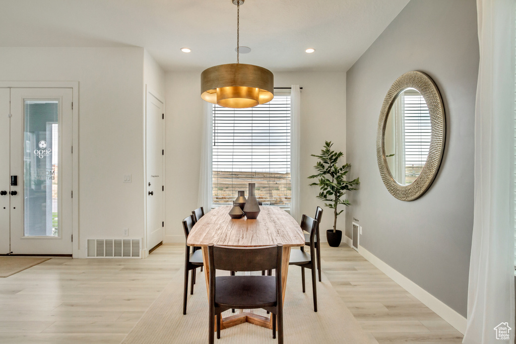 Dining room featuring light wood finished floors, plenty of natural light, and recessed lighting