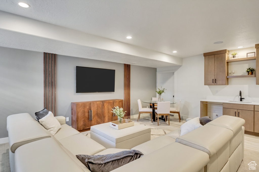 Living area with recessed lighting, wet bar, and baseboards