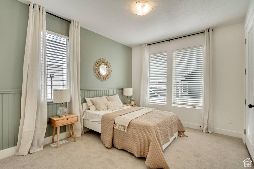 Bedroom featuring carpet and baseboards