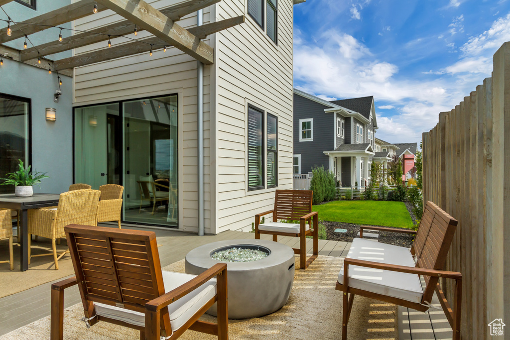 View of patio / terrace with an outdoor fire pit and a pergola