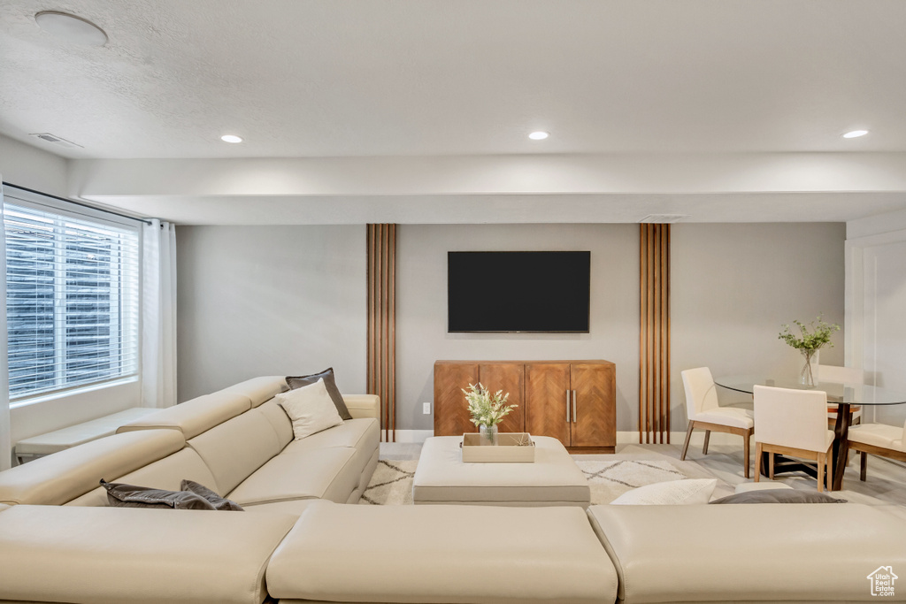 Living area with recessed lighting and baseboards
