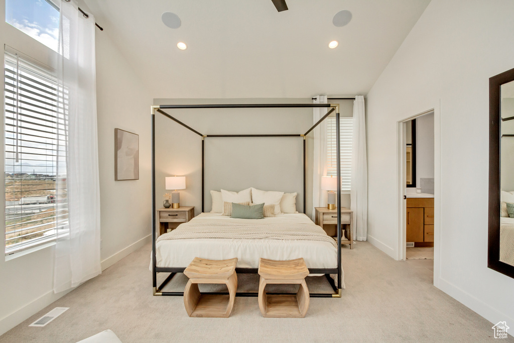 Bedroom with light carpet, baseboards, recessed lighting, and connected bathroom