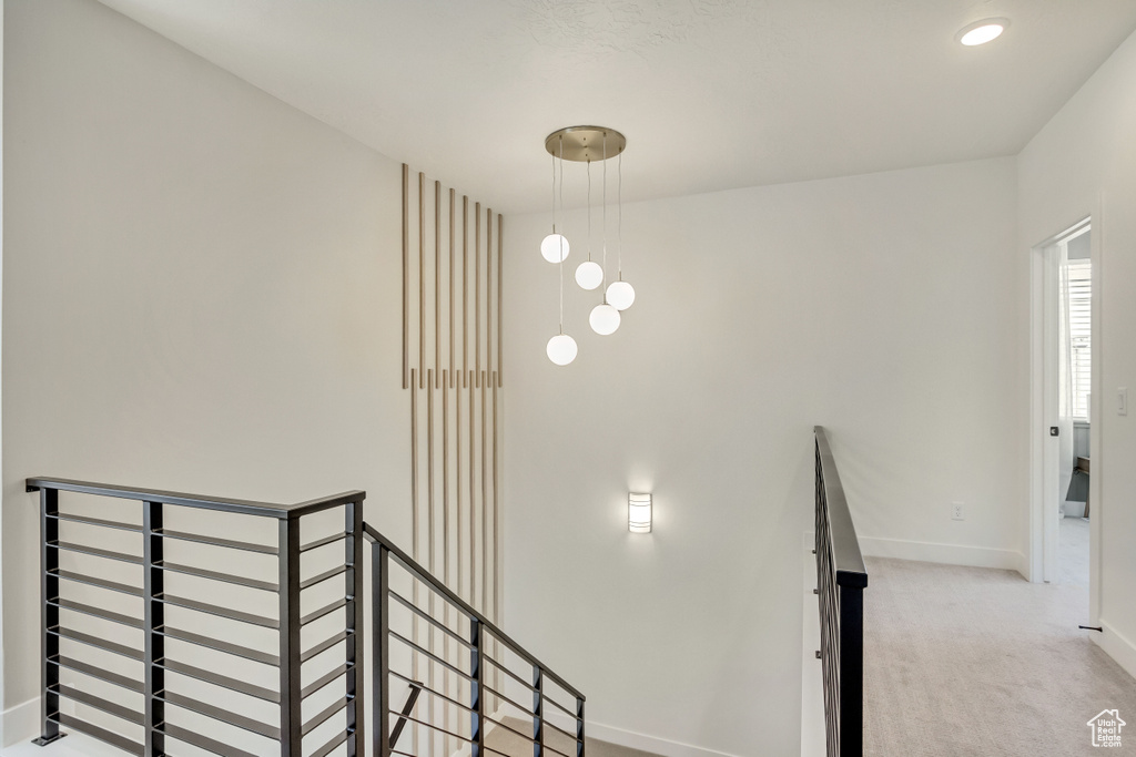 Stairs featuring baseboards and carpet