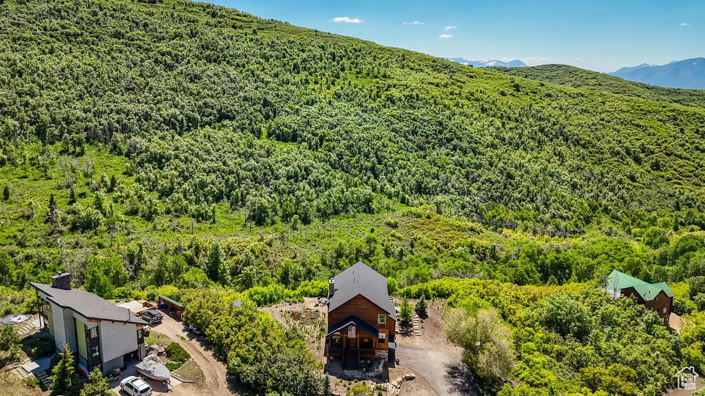 View from above of property featuring a forest and a mountain backdrop