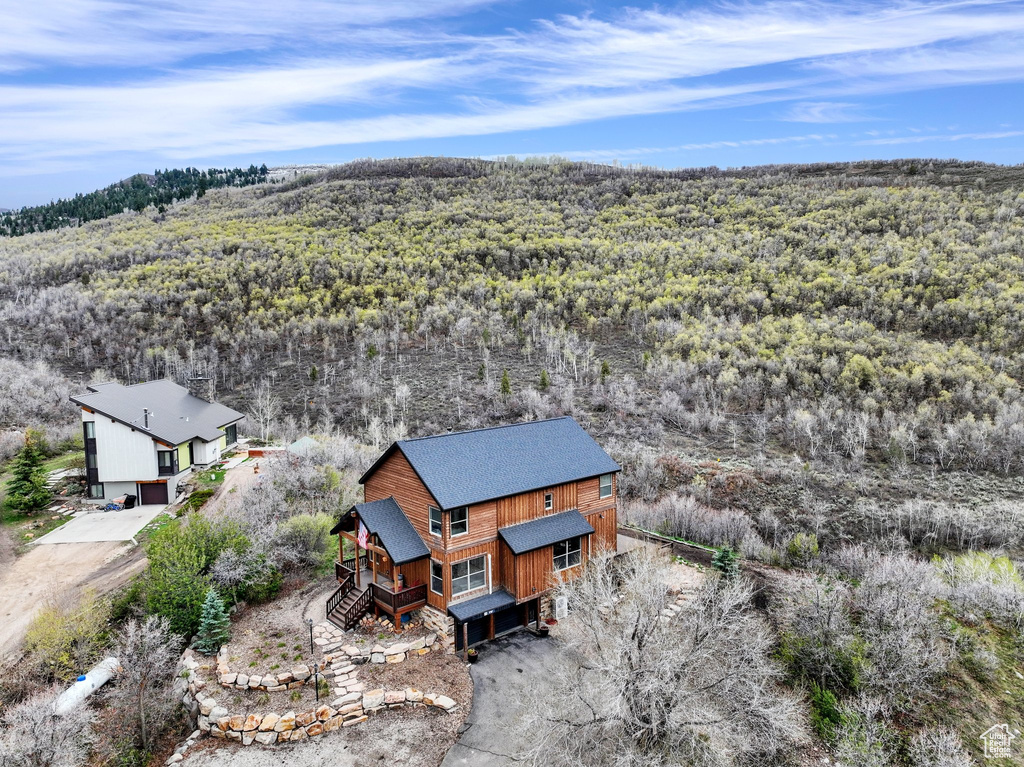 View from above of property featuring a heavily wooded area