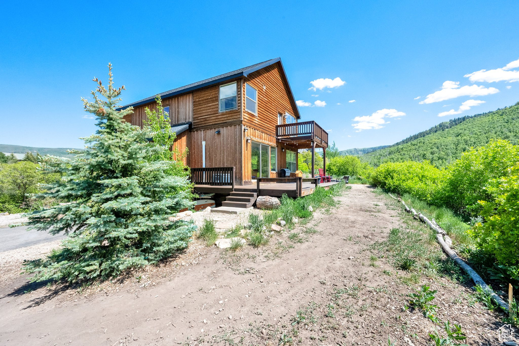 Back of house with a wooden deck