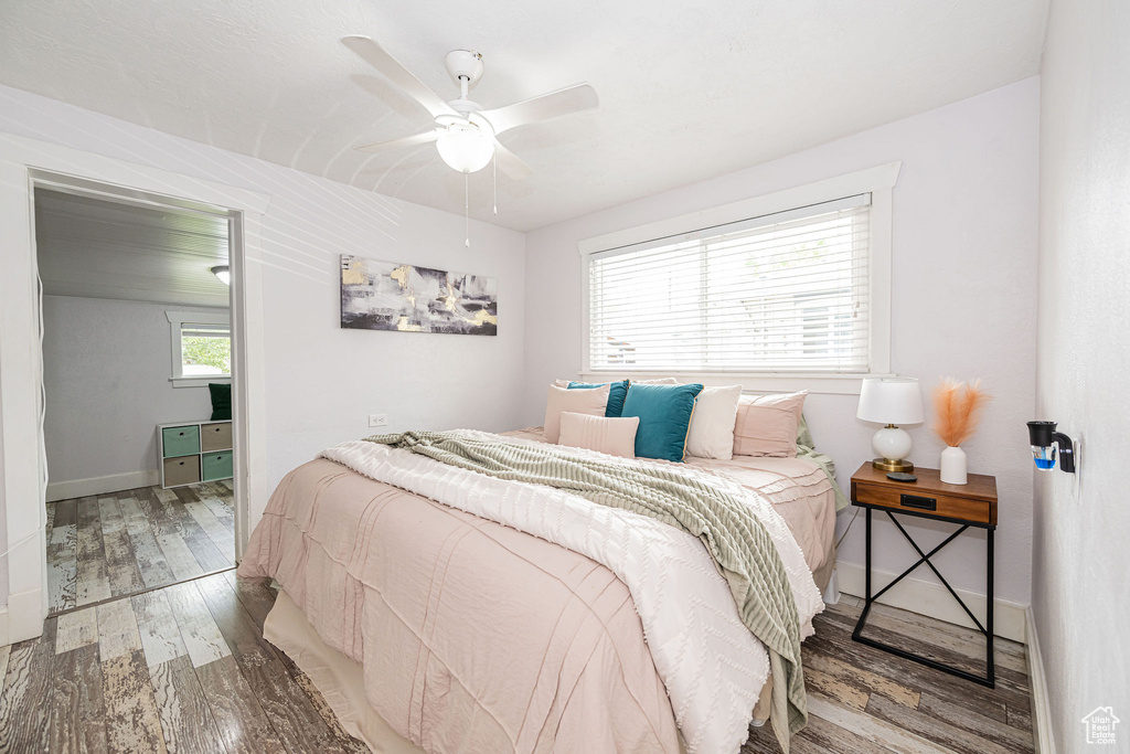 Bedroom with wood finished floors, baseboards, and a ceiling fan