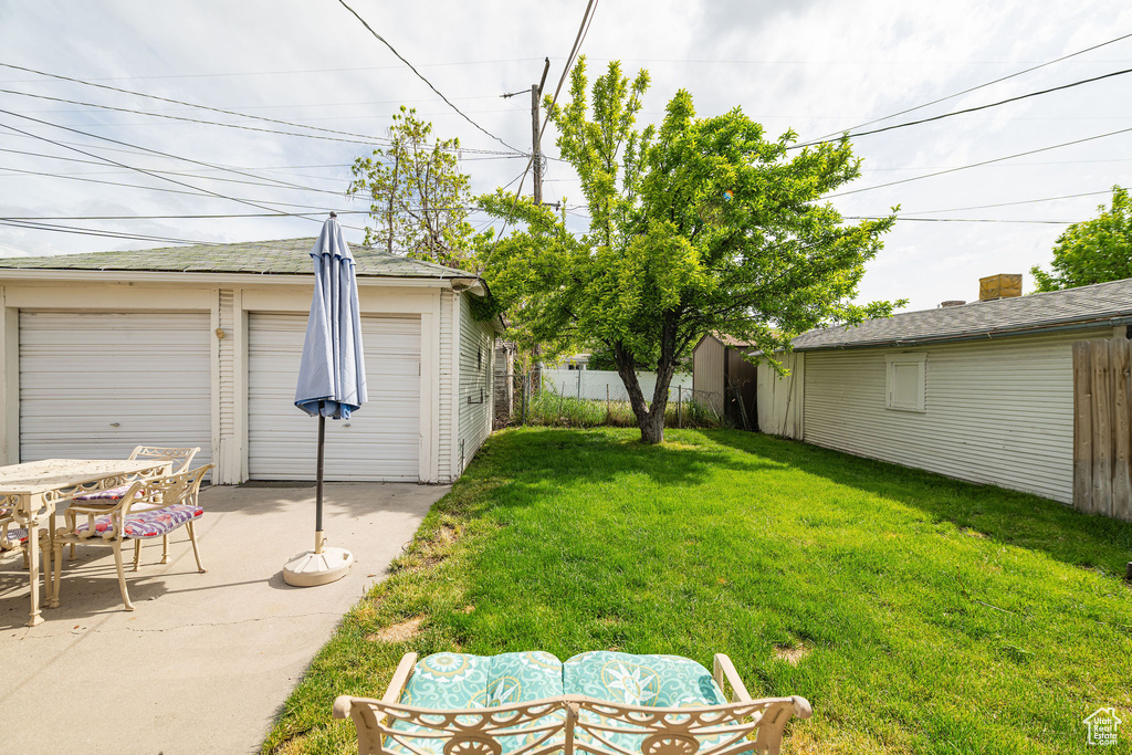 View of yard featuring a patio area and an outbuilding