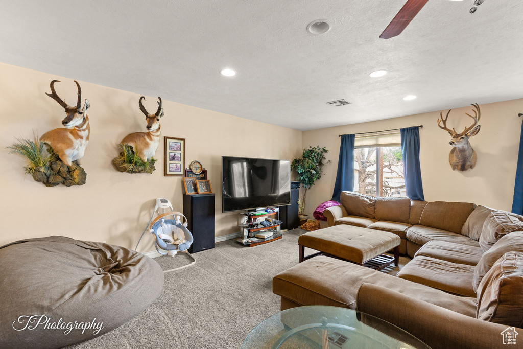 Living room featuring carpet floors, recessed lighting, ceiling fan, and baseboards