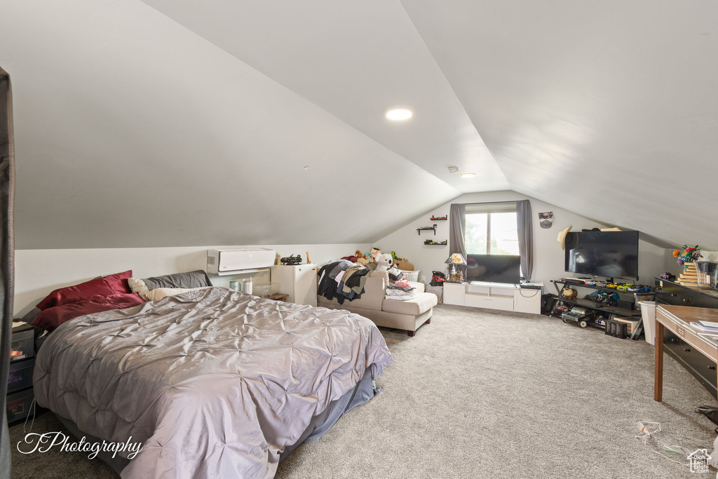 Carpeted bedroom featuring vaulted ceiling