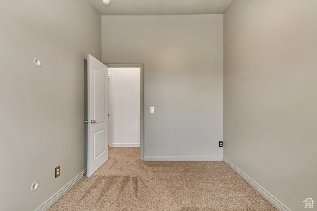Empty room featuring carpet floors and baseboards