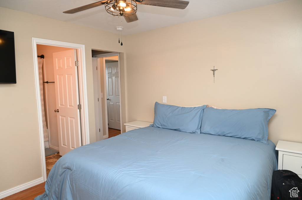 Bedroom featuring baseboards, ceiling fan, and wood finished floors