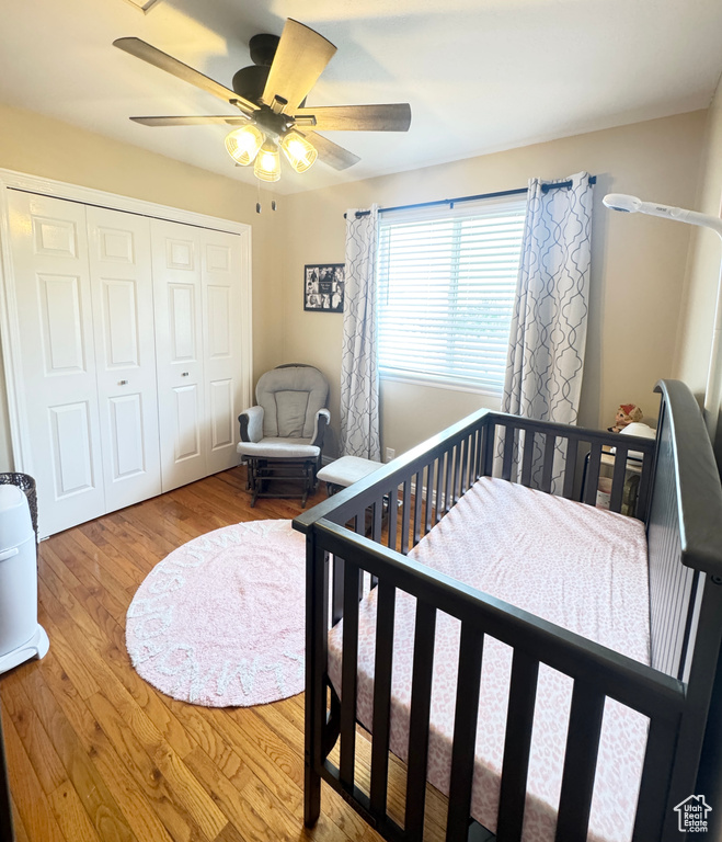 Bedroom featuring a closet, ceiling fan, and wood finished floors