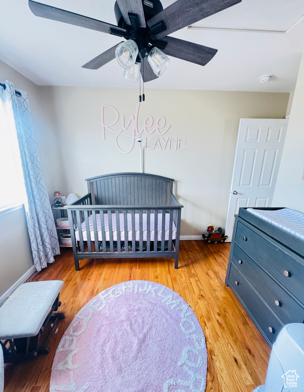 Bedroom with baseboards, light wood-style flooring, and a ceiling fan