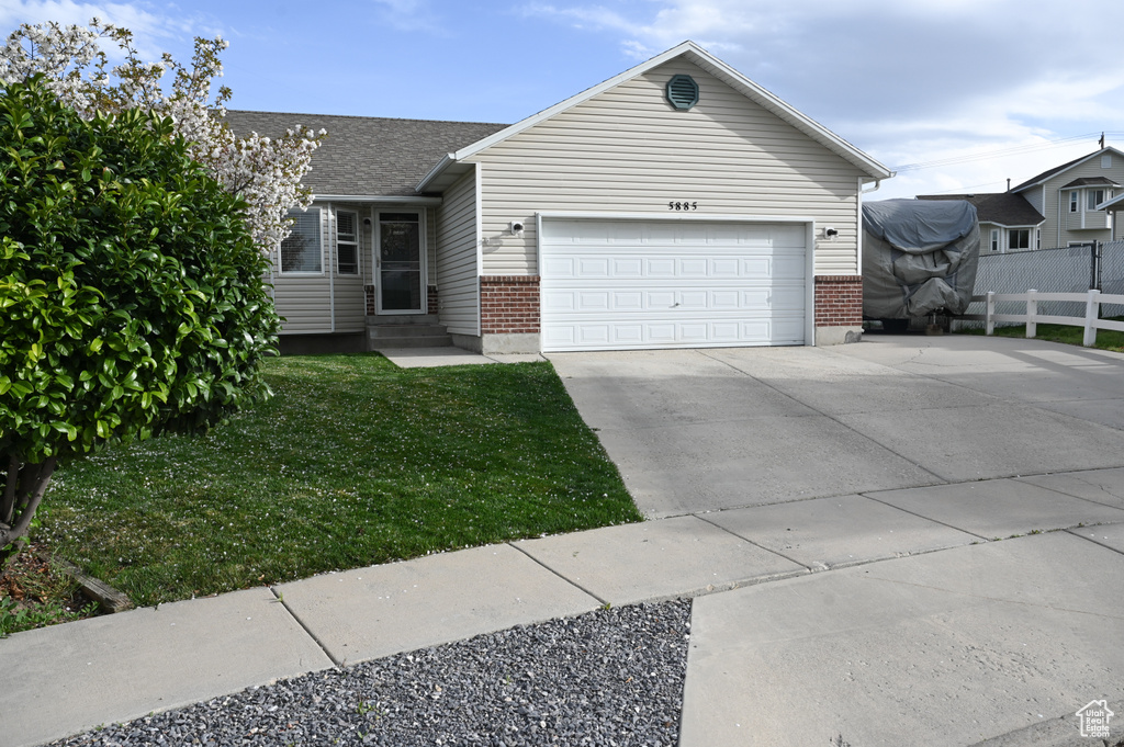 Single story home featuring entry steps, fence, brick siding, and driveway