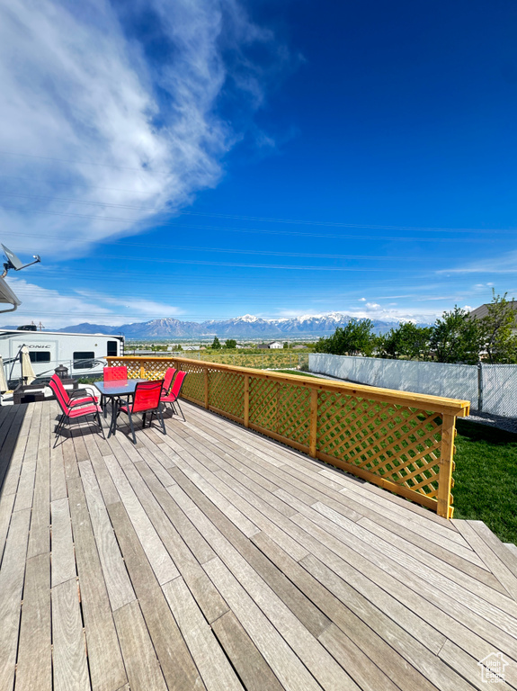 Wooden terrace with outdoor dining area and a mountain view