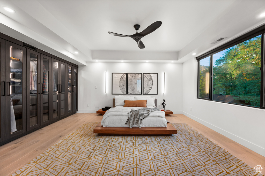 Bedroom with baseboards, visible vents, light wood finished floors, and recessed lighting