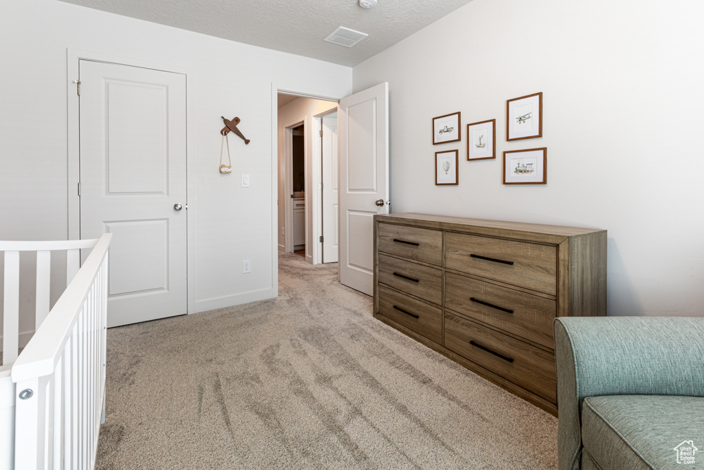 Bedroom featuring light colored carpet and baseboards