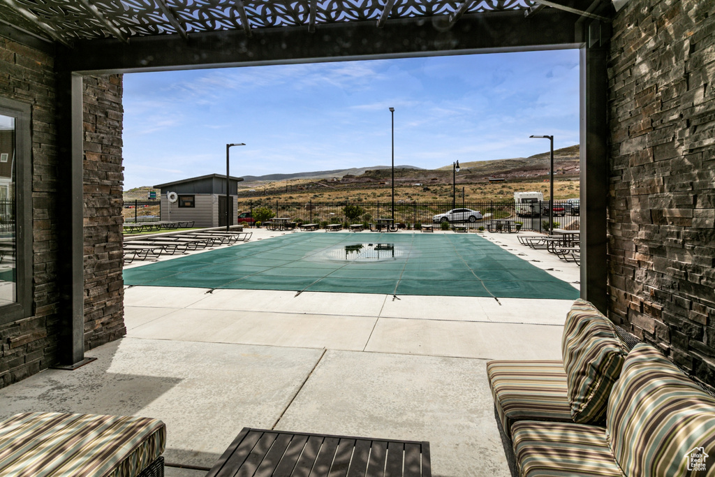 Community pool with a mountain view and a patio