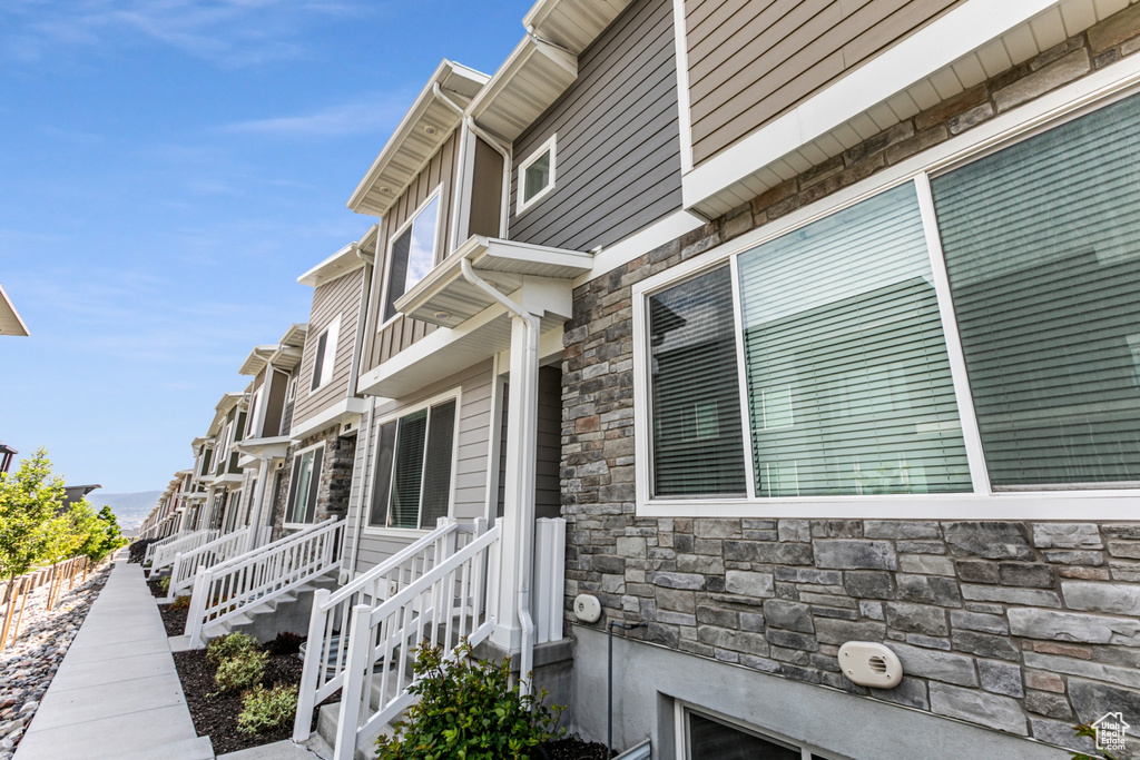 View of side of home featuring stone siding