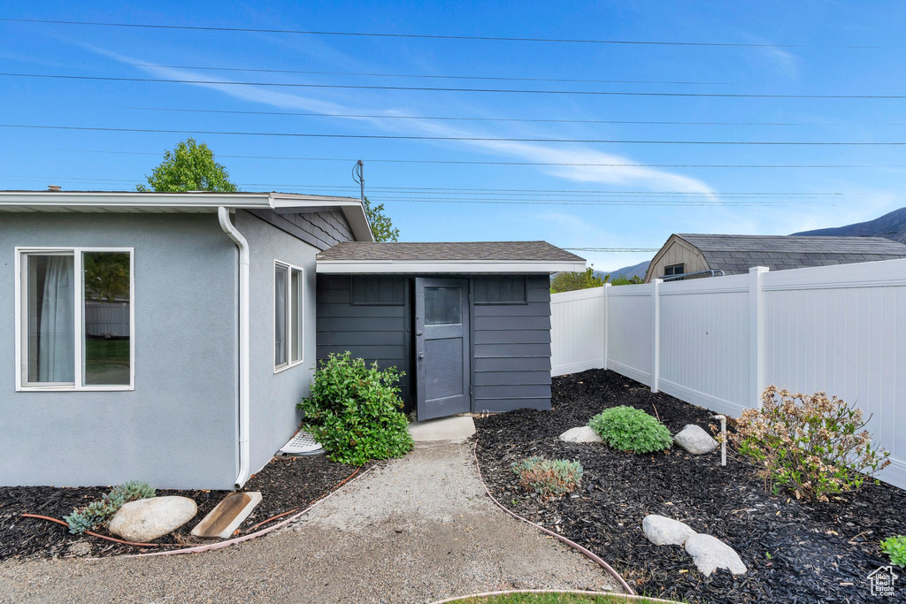 Property entrance with fence and stucco siding