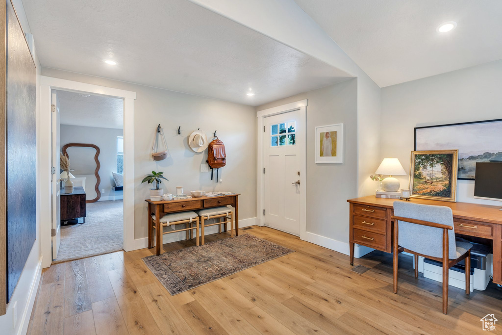 Foyer with light wood finished floors, baseboards, and recessed lighting