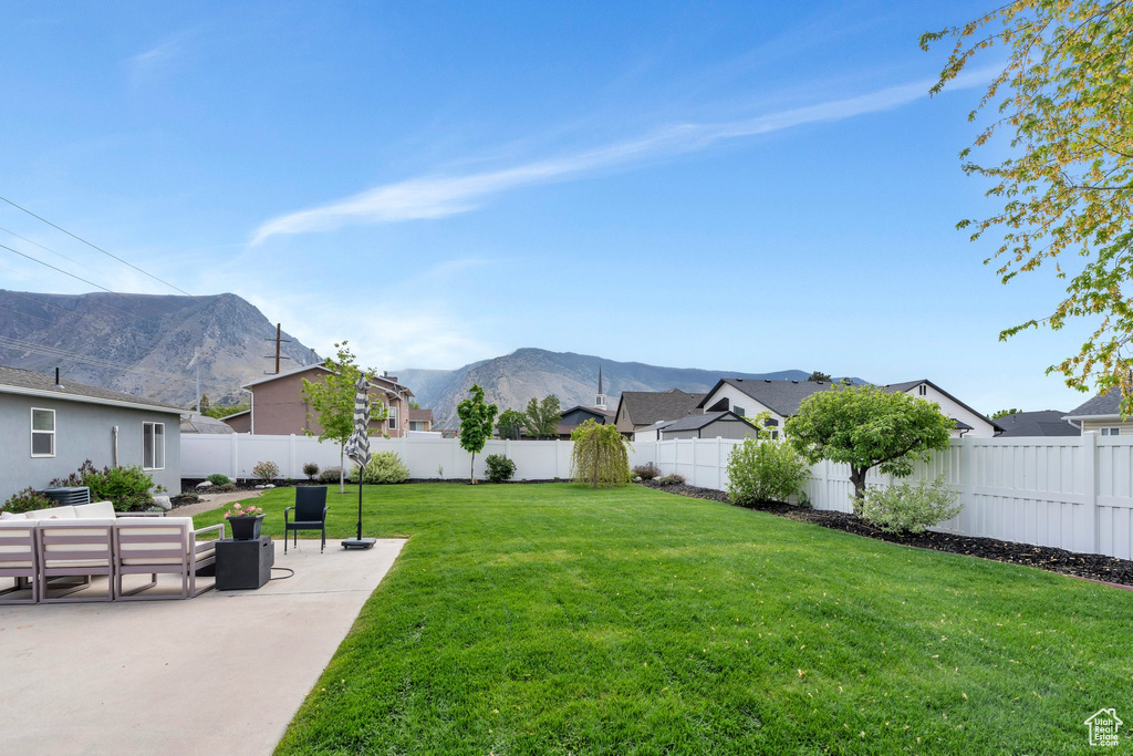 View of yard featuring a mountain view, a patio area, and a residential view
