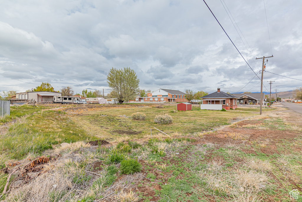 View of yard featuring a storage unit and an outbuilding