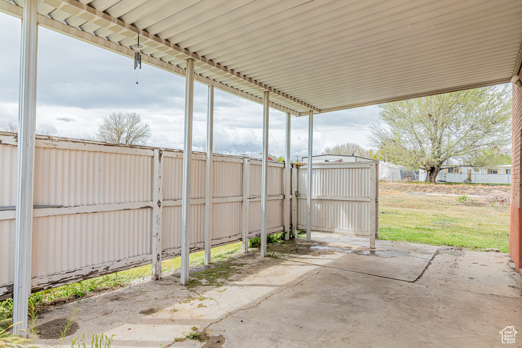 View of patio featuring fence