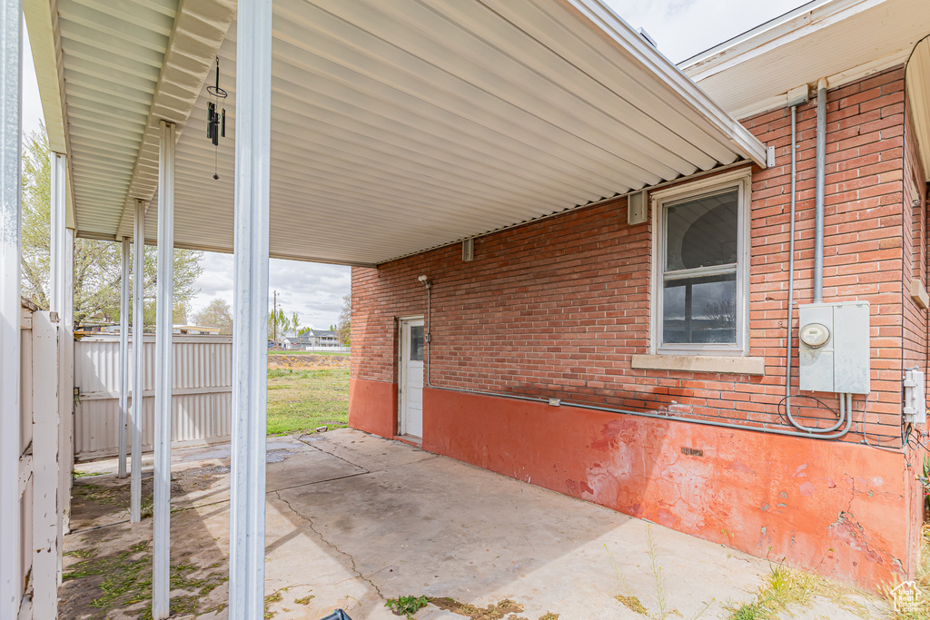 View of patio / terrace with fence and an attached carport