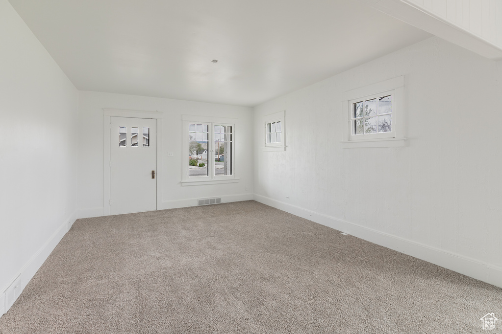 Empty room with carpet flooring and baseboards