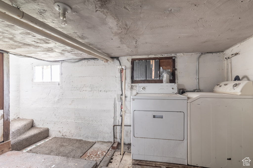 Clothes washing area featuring washer and clothes dryer