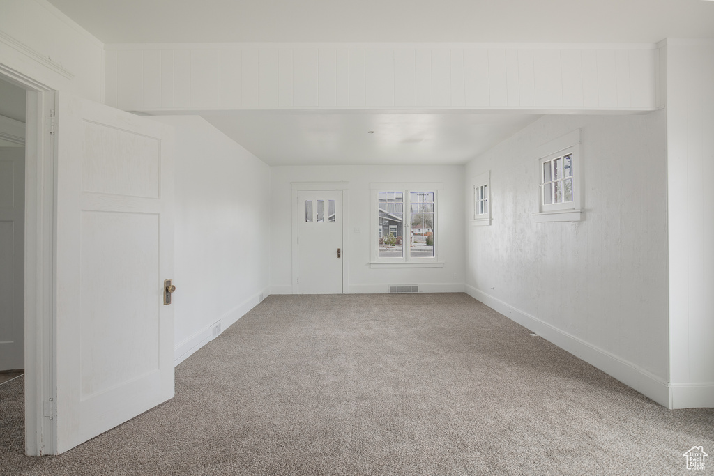 Unfurnished room featuring carpet floors and baseboards